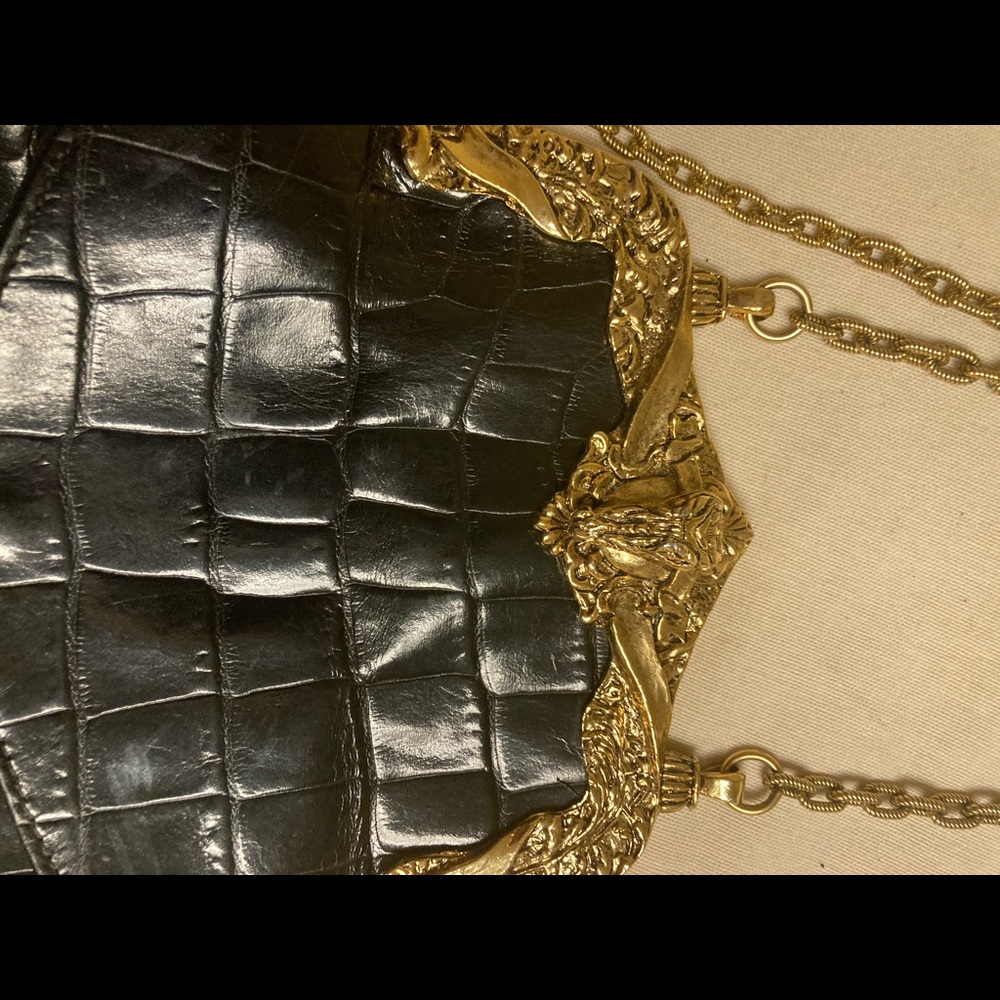 Alligator- look shoulder bag with gold chain strap.